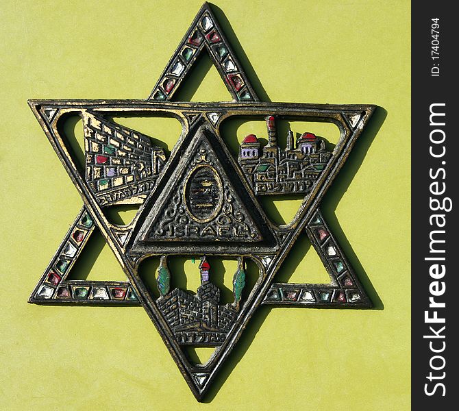 Antique decorative metal colorful star of David on light background.Jerusalem fleamarket. Antique decorative metal colorful star of David on light background.Jerusalem fleamarket.