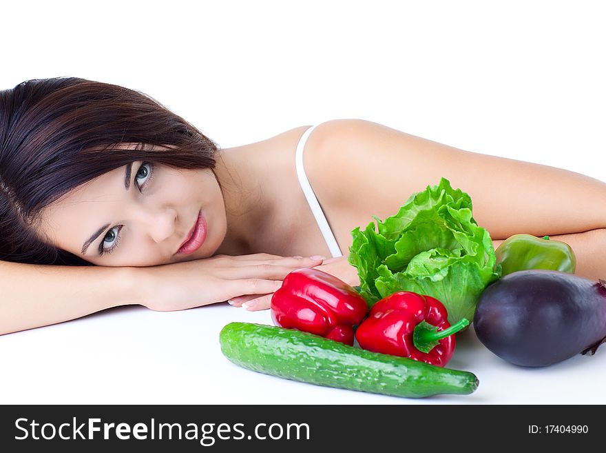 Young girl with  vegetables over white background