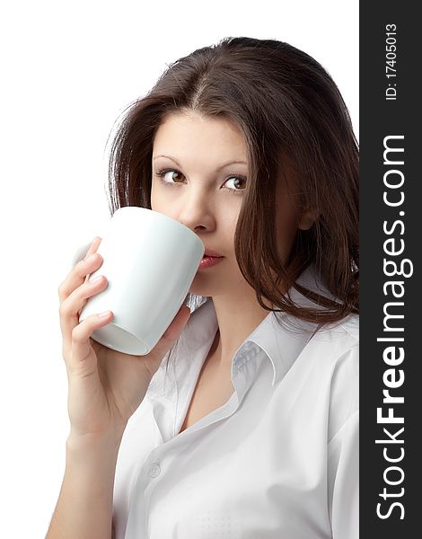 A beautiful young female woman enjoying a cup of tea/coffee. A beautiful young female woman enjoying a cup of tea/coffee