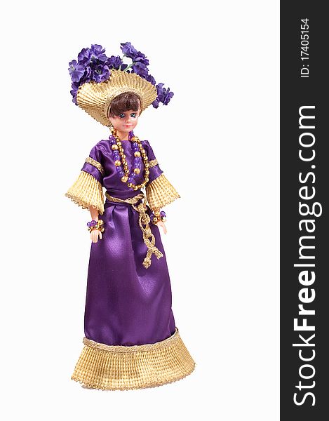 Girl's doll wearing handmade dress and hat. She wears a purple dress with gold trim and a gold hat with purple flowers. Girl's doll wearing handmade dress and hat. She wears a purple dress with gold trim and a gold hat with purple flowers.