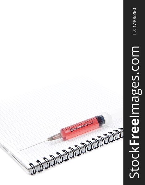 Syringe on a notebook