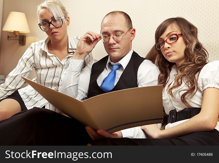 Portrait of confident associates looking at business document