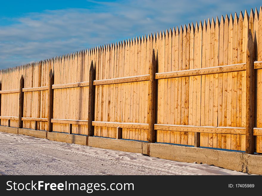 Wooden roadside fence at winter season. Wooden roadside fence at winter season