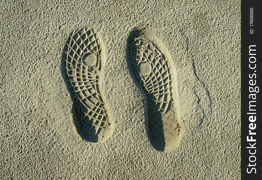 Footprints on sand of an italian beach