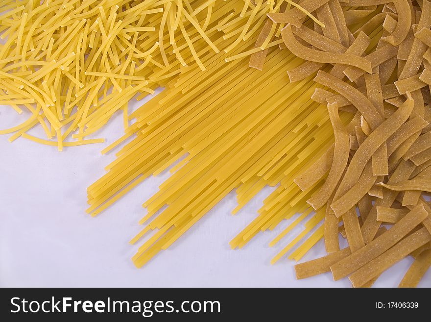 Different pasta on white background