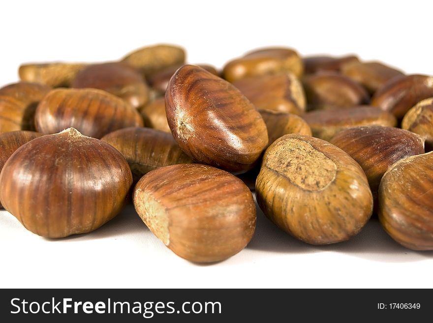 Brown chestnuts on white background