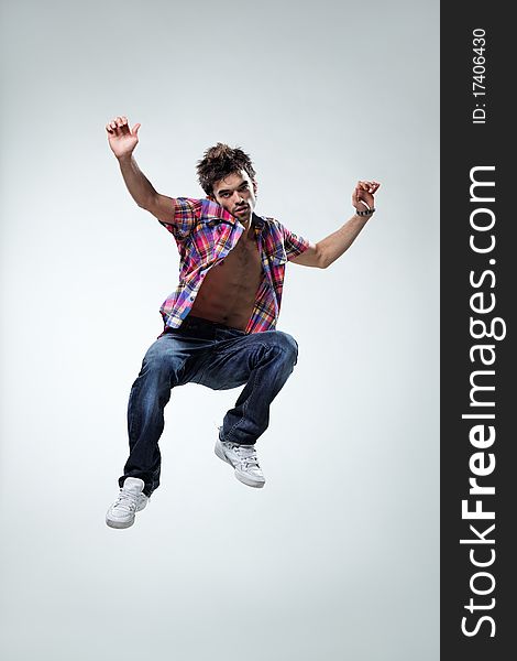 Modern style dancer jumping on studio background. Modern style dancer jumping on studio background