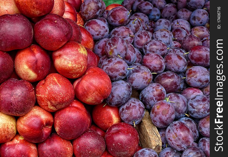 Plums and nectarines at an outdoor market in Paris France. Plums and nectarines at an outdoor market in Paris France