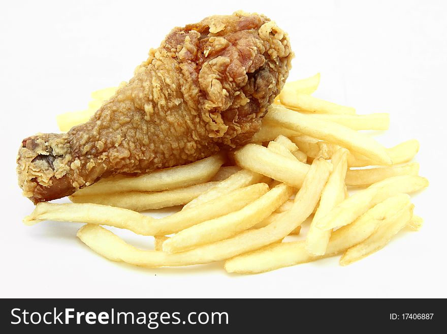 Isolated golden brown crispy fried chicken drumsticks with french fries