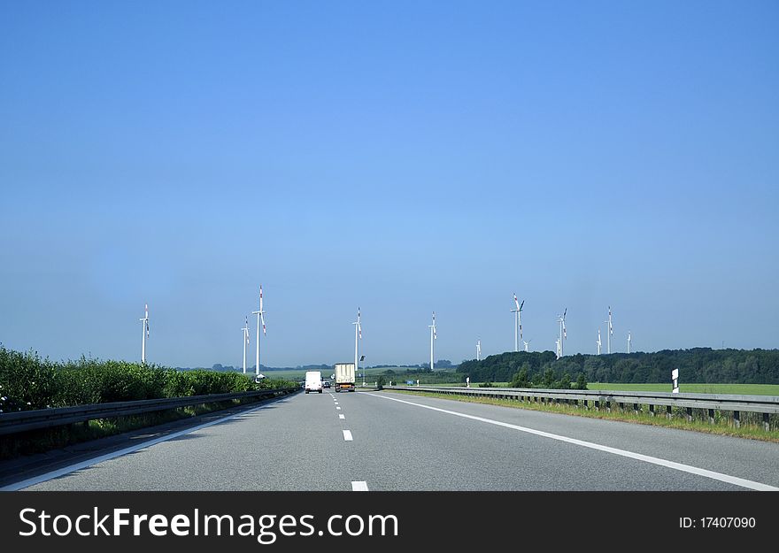 Highway and wind turbines in the foreground