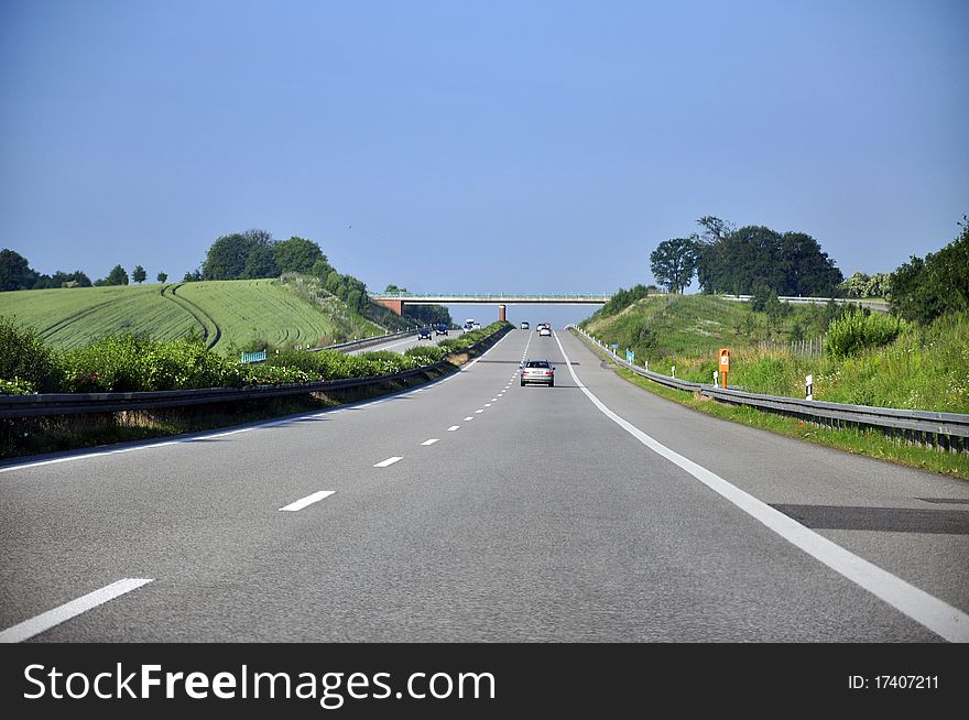 An image of highway during sunny day