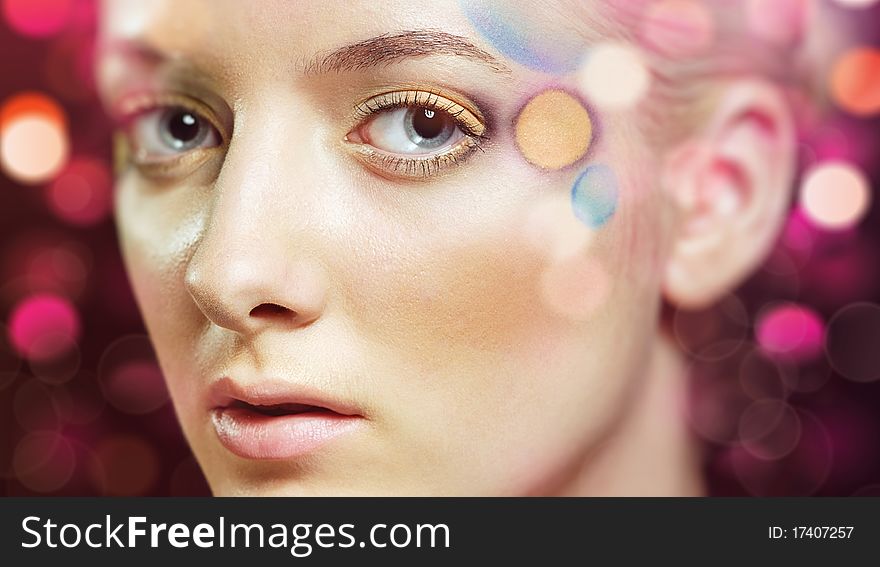 Portrait of a beautiful dreaming woman in coloured lens flares. Portrait of a beautiful dreaming woman in coloured lens flares