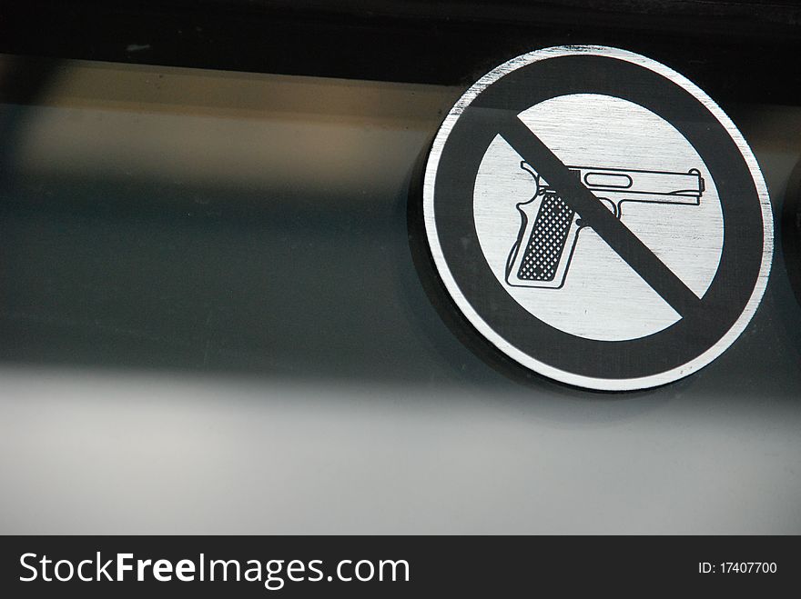 Sign showing a prohibition on weapons in a public space. Sign showing a prohibition on weapons in a public space