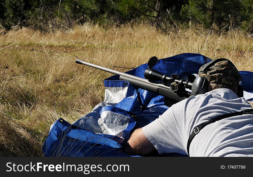 Close up image of male shooting rifle. Close up image of male shooting rifle