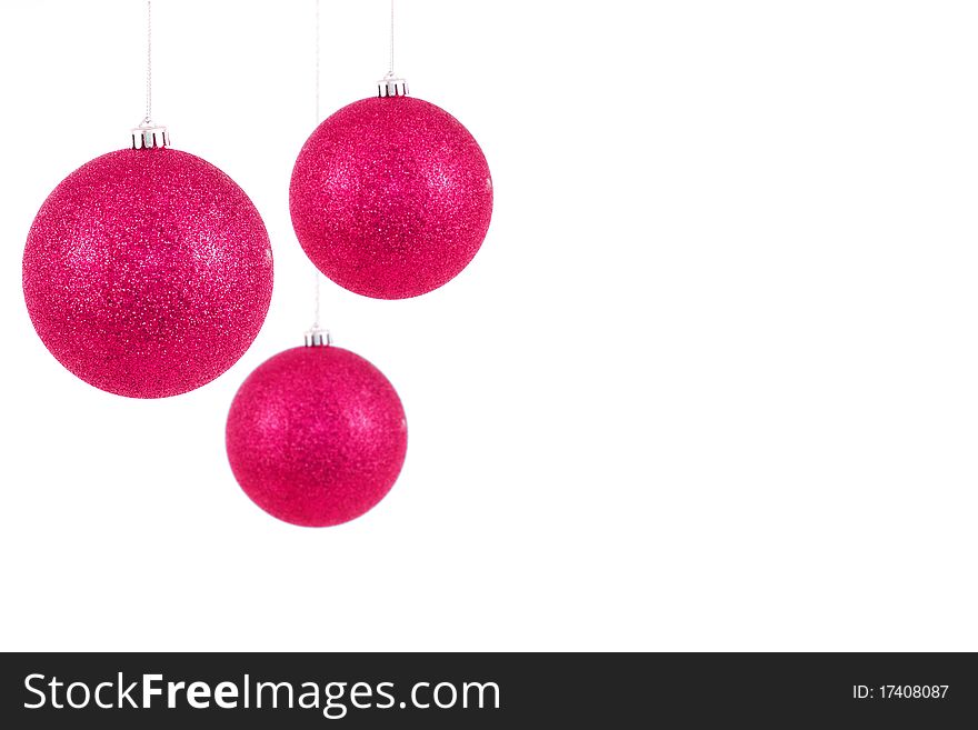 Christmas crystal balls hanging on ribbons, over white background