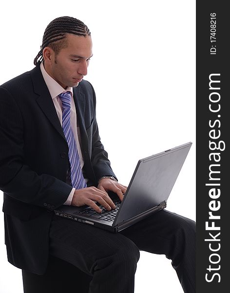 Photograph showing young business man isolated against white on laptop computer