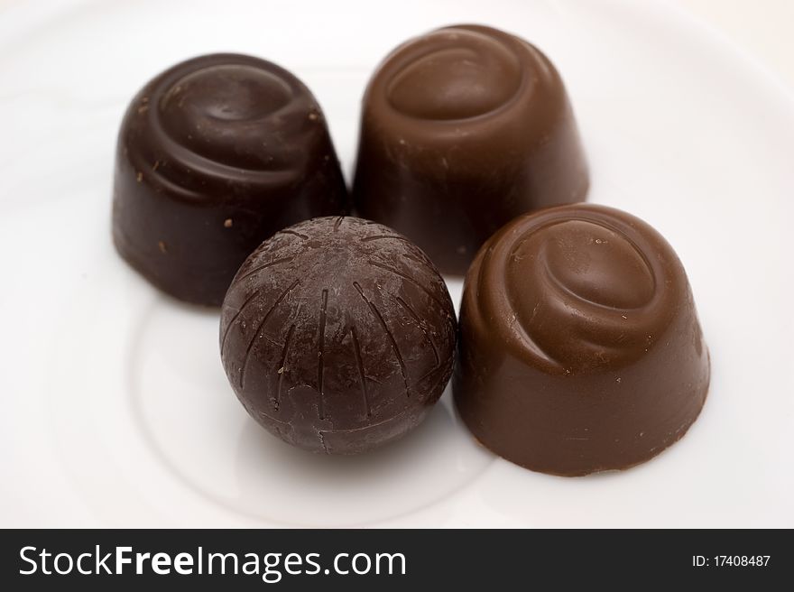 Chocolate candies with stuffing on a white backgrounds closeup