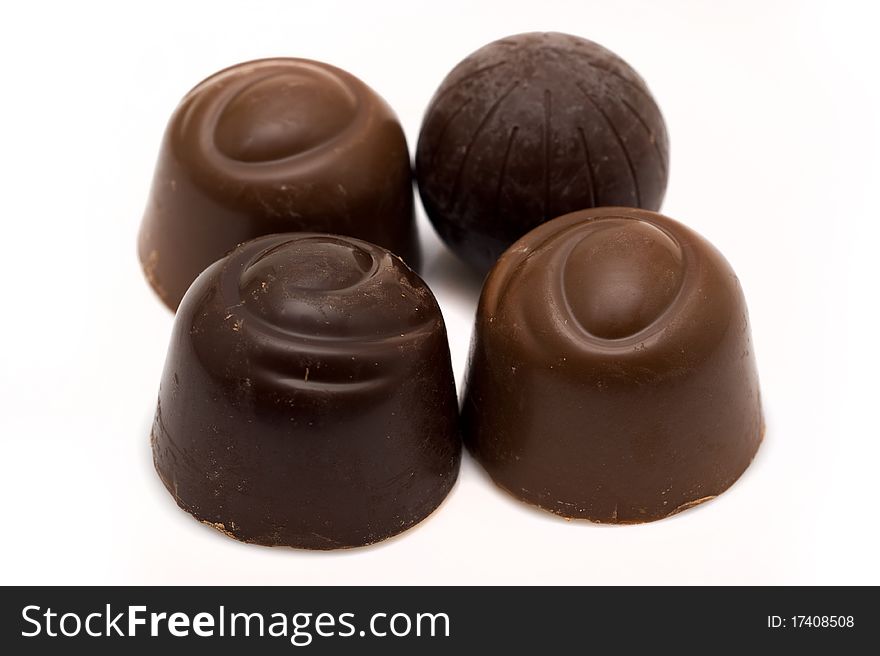 Chocolate candies with stuffing on a white backgrounds closeup