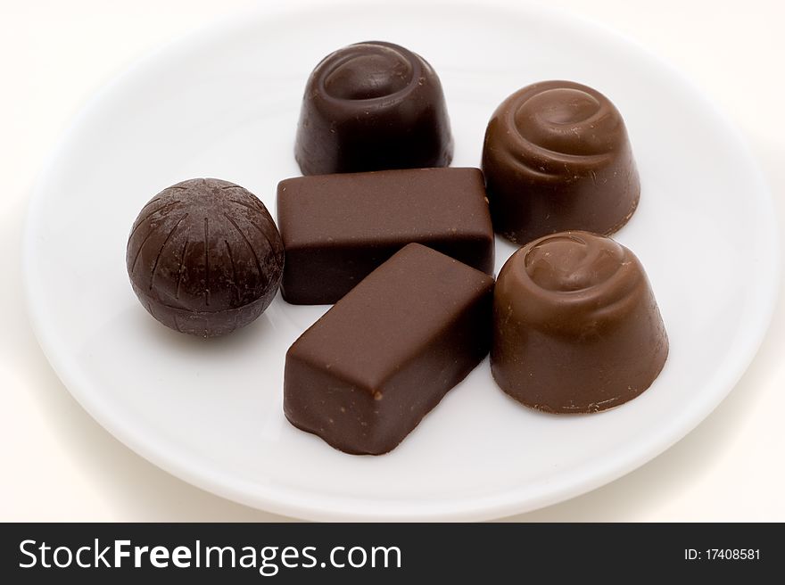 Chocolate candies with stuffing on a white backgrounds closeup