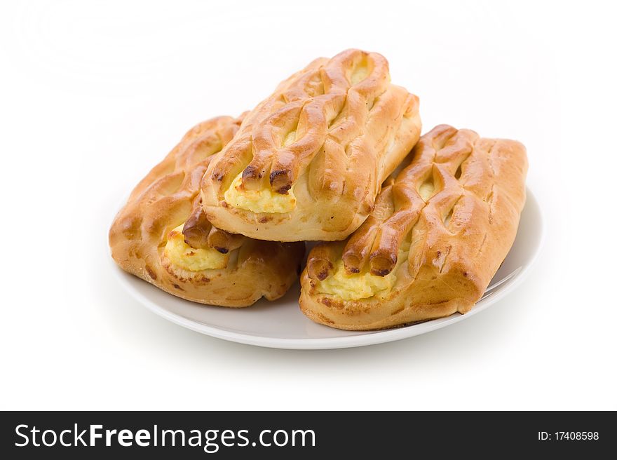 Delicious wheat muffins sweet tasty with cottage cheese on a white background closeup. Delicious wheat muffins sweet tasty with cottage cheese on a white background closeup