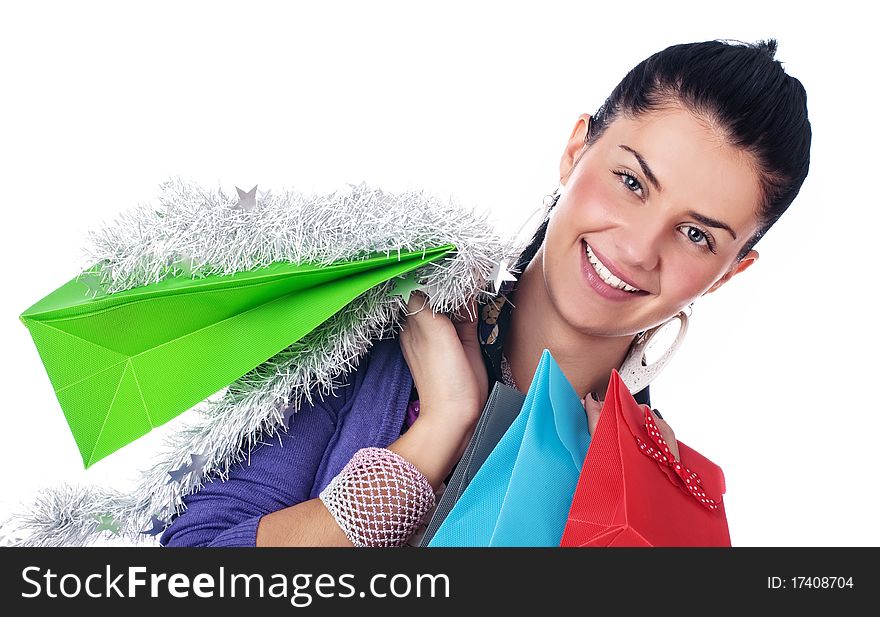 Happy girl with christmas decorations and bags, isolated. Happy girl with christmas decorations and bags, isolated