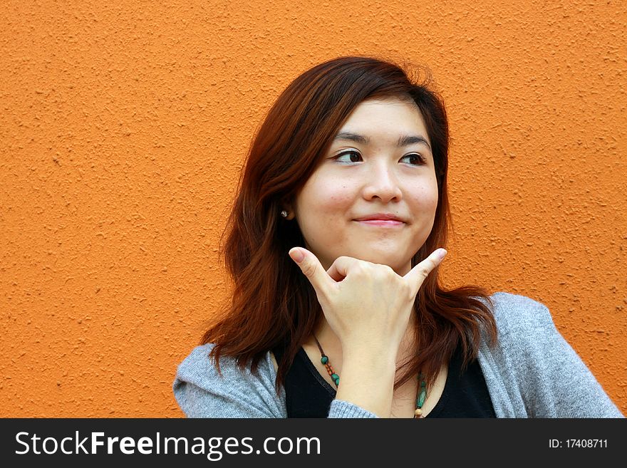 A beautiful Chinese girl pretending call phone. A beautiful Chinese girl pretending call phone.