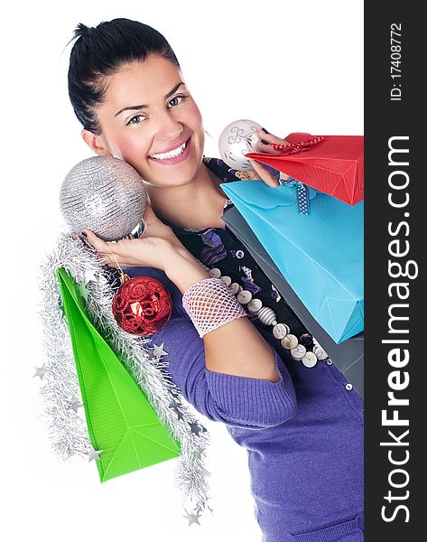 Happy girl with christmas decorations and bags, isolated. Happy girl with christmas decorations and bags, isolated