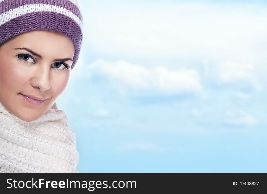 Beautiful young woman in warm clothing, sky at background. Beautiful young woman in warm clothing, sky at background