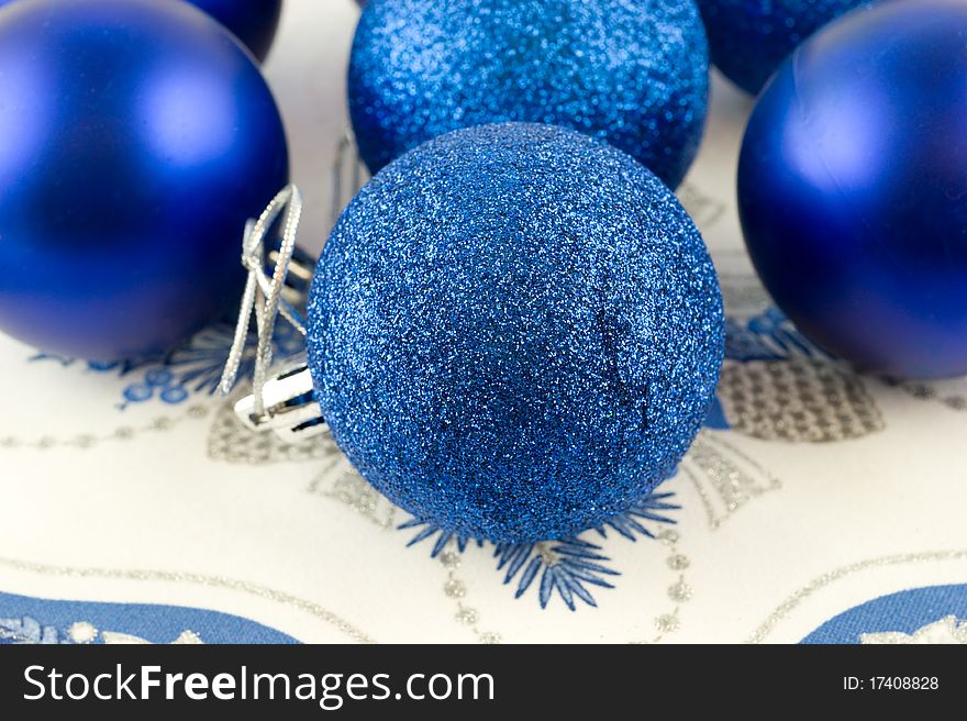 Christmas-tree decorations - blue glass balls are on a napkin closeup