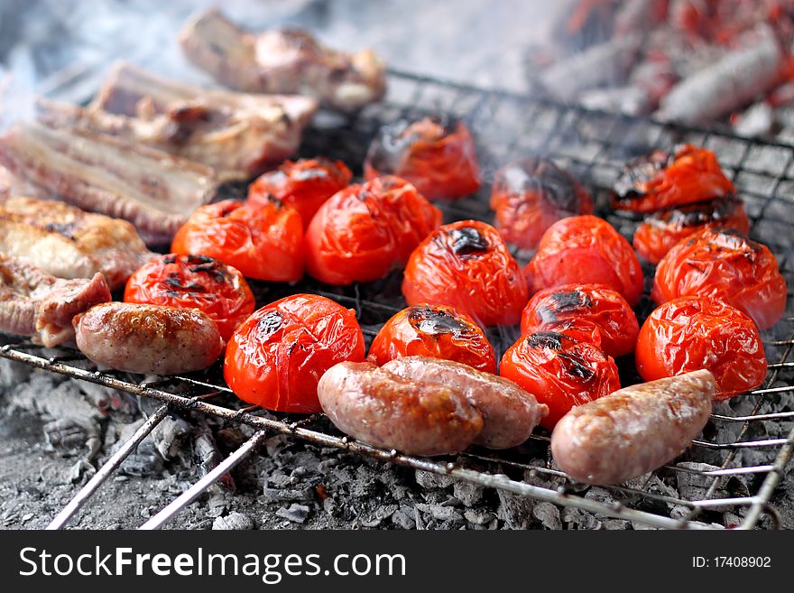 Barbecue with tomatoes, sausages and ribs. Barbecue with tomatoes, sausages and ribs