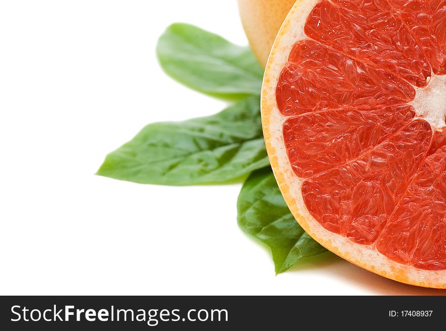 Fresh juicy grapefruits with green leafs. Isolated