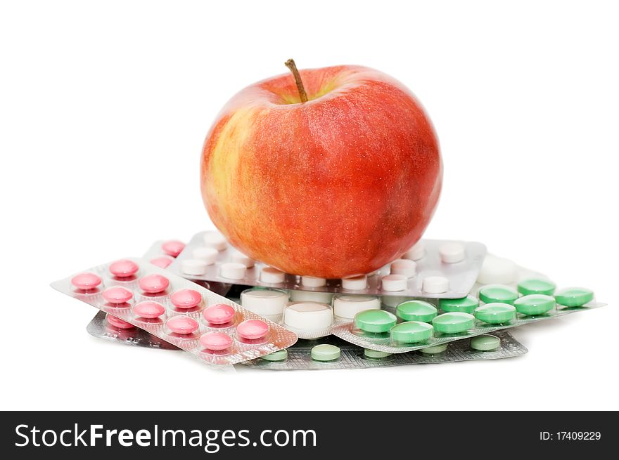 Apple with pills  isolated on white background. Apple with pills  isolated on white background