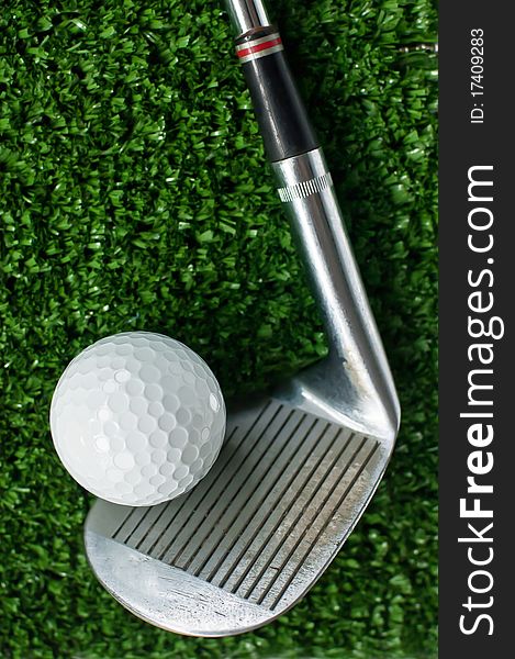 Golf Ball and putter on green grass background