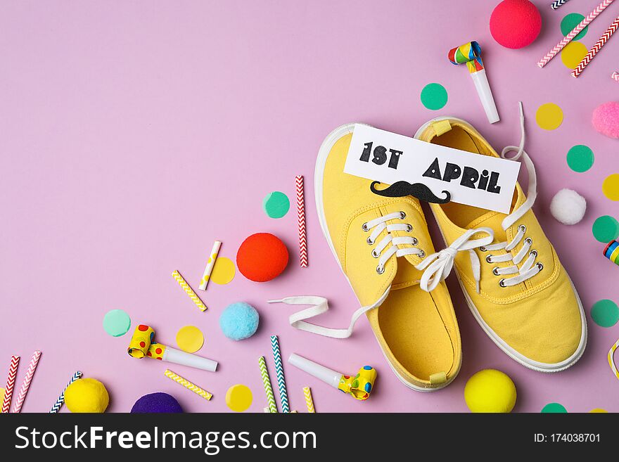 Shoes Tied Together And Note With Phrase 1st APRIL On Background, Flat Lay. Space For Text