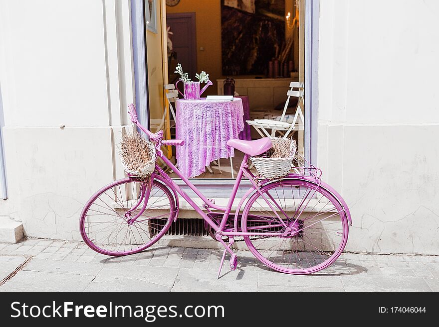 Vintage purple bicycle as decoration near cafe
