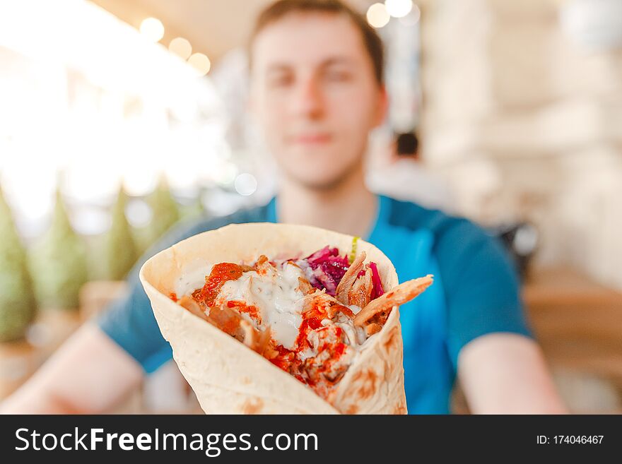 Man eating Doner Kebap its a midlle eastern fast food cuisine