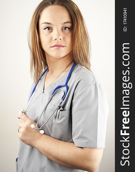 Young woman doctor or nurse wearing gray scrubs