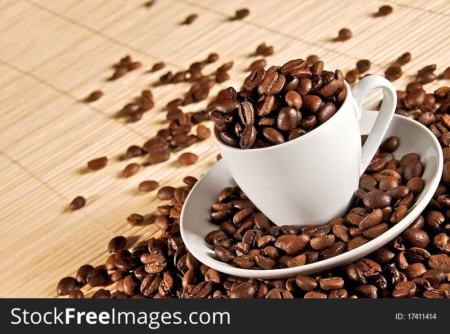 Cup full of coffee beans on table. Cup full of coffee beans on table