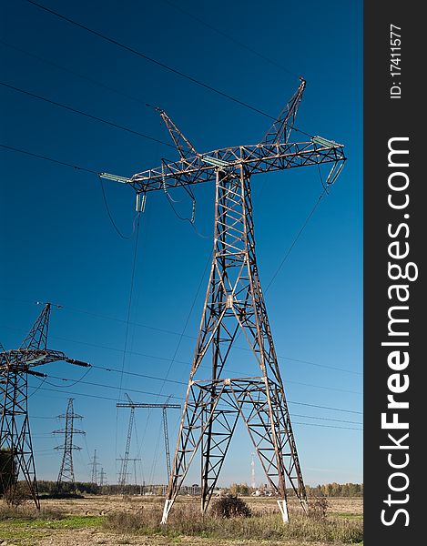 High-voltage electric main on a background of the clear dark blue sky