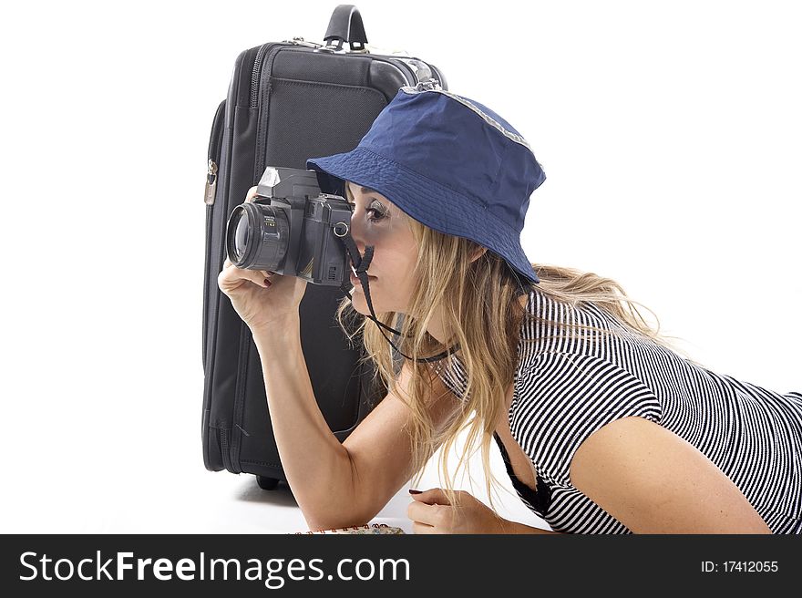 Smiling tourist woman with her suitcase taking photograhs. Smiling tourist woman with her suitcase taking photograhs