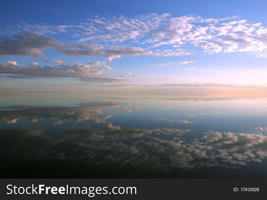 Sky and clouds reflectes in the water. Sky and clouds reflectes in the water