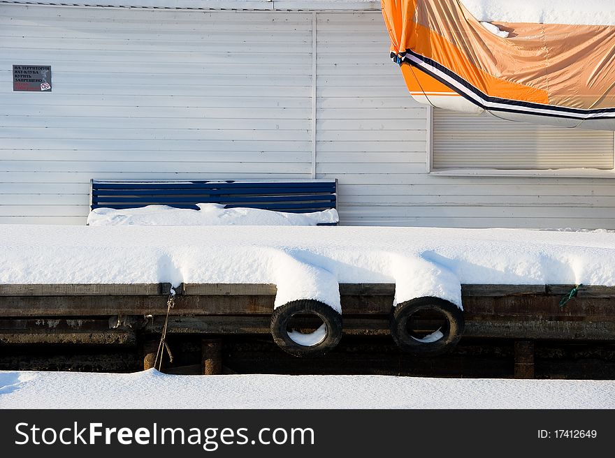 Snow-covered pier of yacht club. Snow-covered pier of yacht club