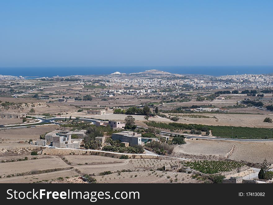 The vast area of Malta bathed in the sun. The sea is visible in the background. The vast area of Malta bathed in the sun. The sea is visible in the background.