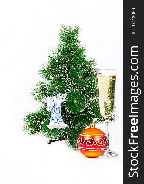 Christmas tree decorated with toys and a glass of champagne on belm background character of the New Year holiday