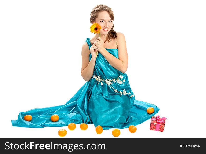 Young beautiful woman with a Christmas gift and tangerines. Young beautiful woman with a Christmas gift and tangerines.