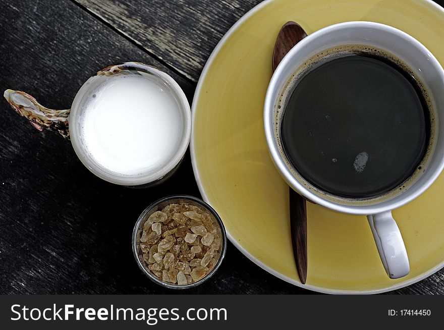 Coffee with milk and brown sugar over wooden. Coffee with milk and brown sugar over wooden