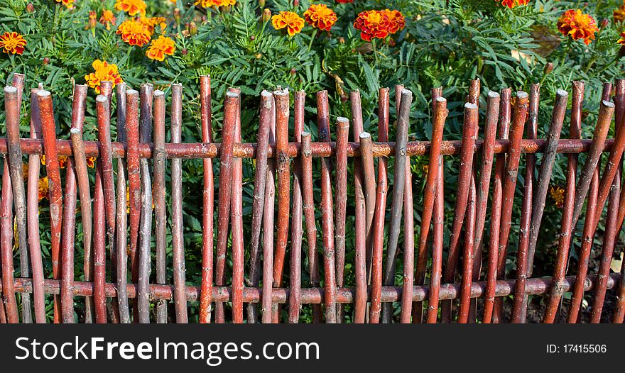 Fence of twigs on a white background.