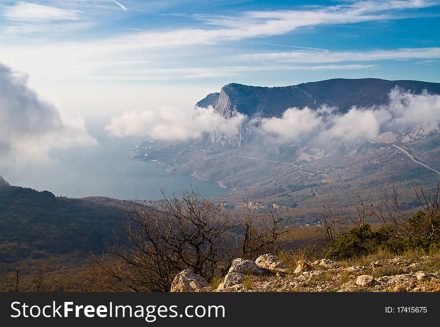 Clouds on a background of mountains and sea. Clouds on a background of mountains and sea