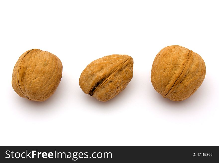 Three walnuts in bulk on a white background.