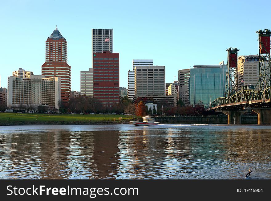 The Portland skyline at sunset with a passing boat. The Portland skyline at sunset with a passing boat.